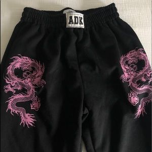 black sweatpants with pink dragons